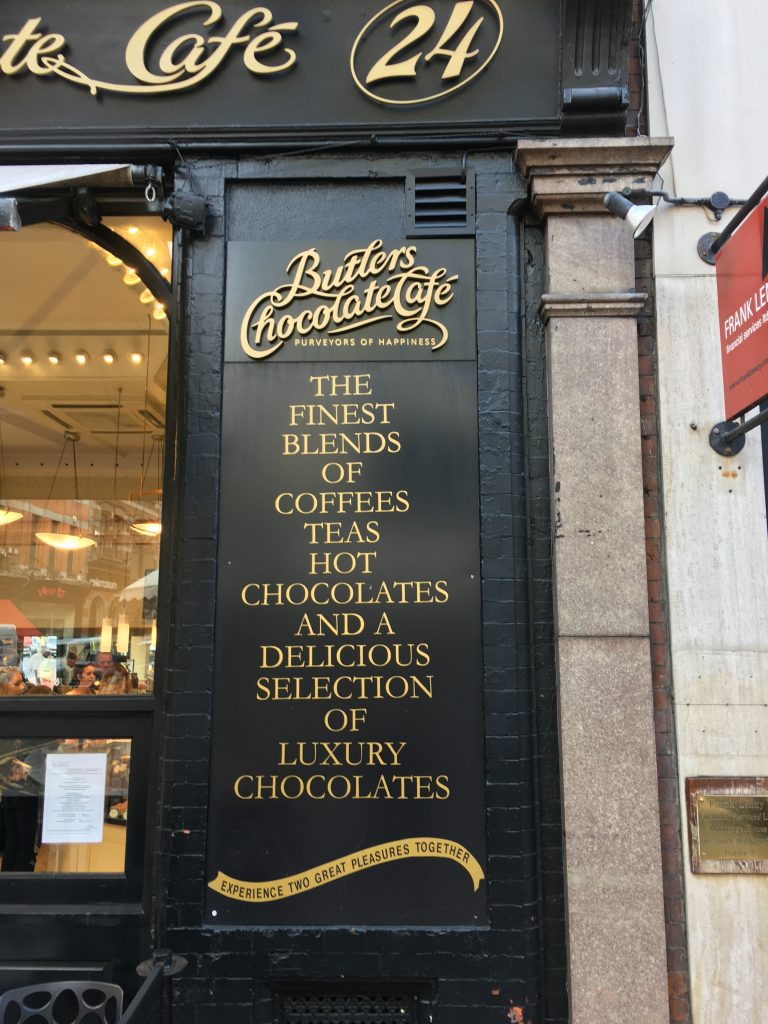 Sign with gold text for Butler’s Chocolate Cafe on Wicklow Street in Dublin, Ireland. ​